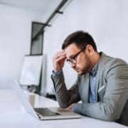 Businessman stressed out at work in casual office.