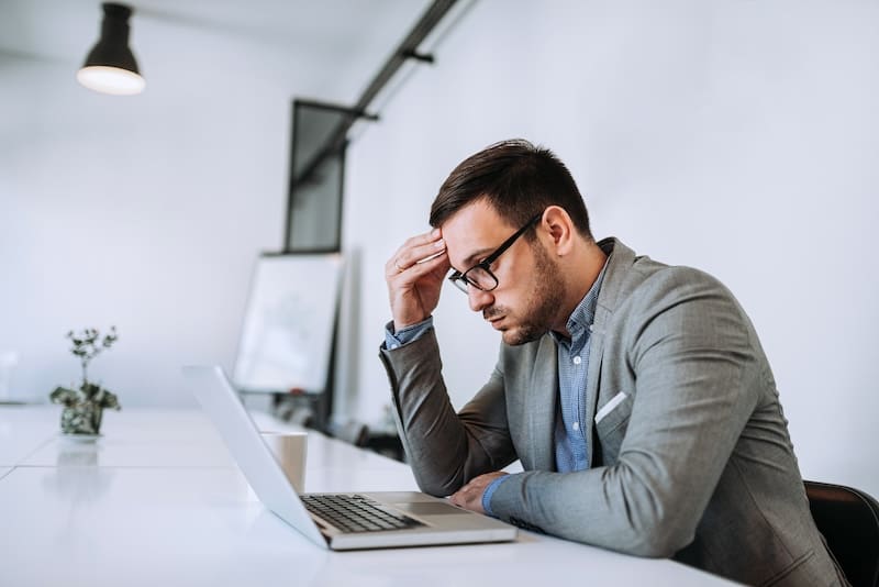 Businessman stressed out at work in casual office.